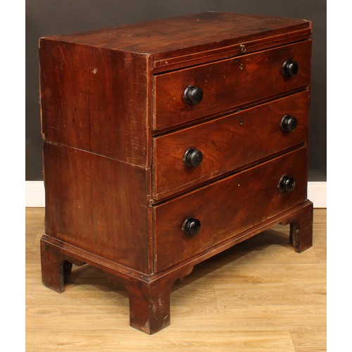 11 - A George III provincial mahogany bachelor’s chest, crossbanded caddy top above a slide and three lon... 