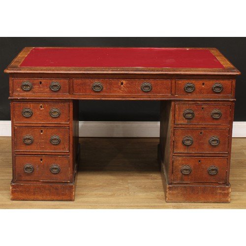 657 - A late 19th/early 20th century oak twin pedestal desk, rectangular top above three frieze drawers, t... 