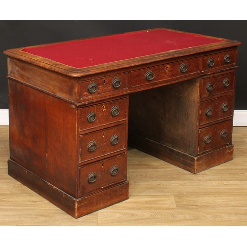 657 - A late 19th/early 20th century oak twin pedestal desk, rectangular top above three frieze drawers, t... 