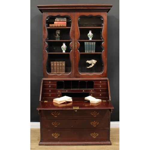 660 - A 19th century mahogany bureau bookcase, dentil cornice above a pair of glazed doors enclosing three... 