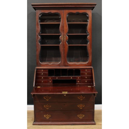 660 - A 19th century mahogany bureau bookcase, dentil cornice above a pair of glazed doors enclosing three... 