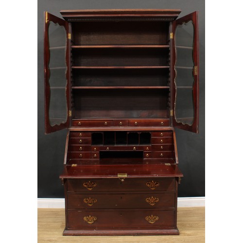 660 - A 19th century mahogany bureau bookcase, dentil cornice above a pair of glazed doors enclosing three... 