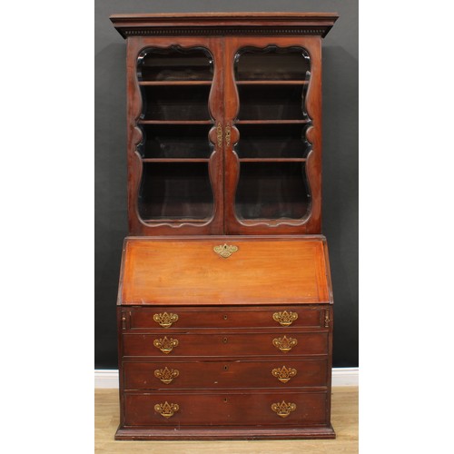 660 - A 19th century mahogany bureau bookcase, dentil cornice above a pair of glazed doors enclosing three... 