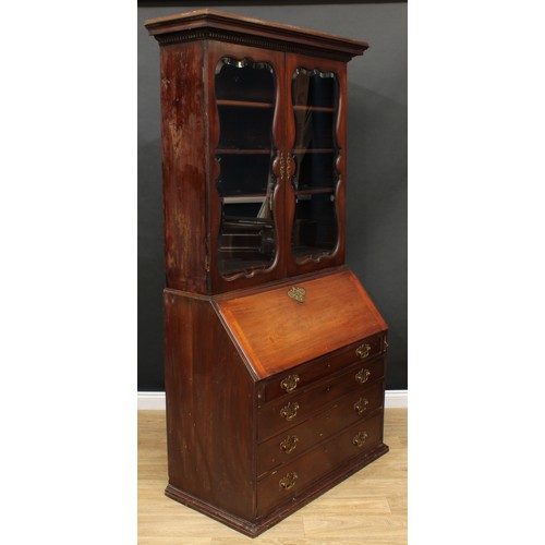 660 - A 19th century mahogany bureau bookcase, dentil cornice above a pair of glazed doors enclosing three... 