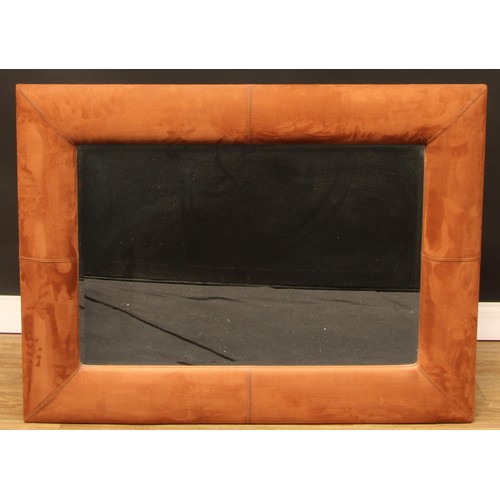 663 - Interior Design - a large faux brown leather wall mirror, 99cm x 99cm overall; another, suede wall m... 