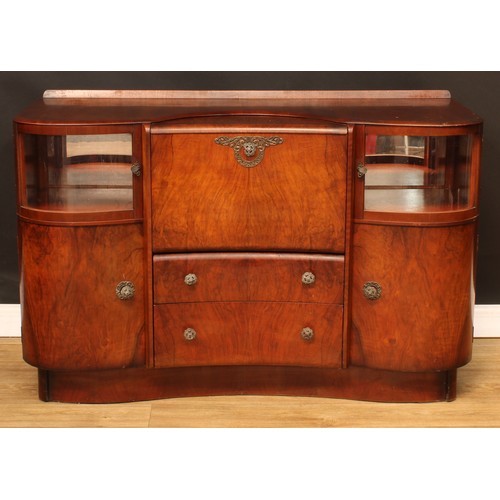 674 - A mid-20th century Art Deco inspired walnut cocktail cabinet, by Beautility, shaped top with shallow... 