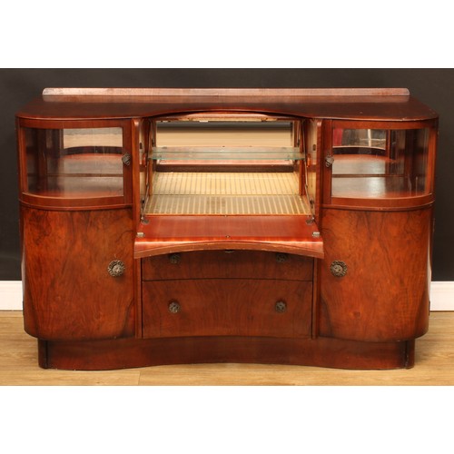 674 - A mid-20th century Art Deco inspired walnut cocktail cabinet, by Beautility, shaped top with shallow... 