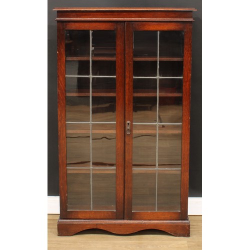 682 - An early 20th century oak lead glazed bookcase, 136cm high, 81cm wide, 29cm deep, c.1935