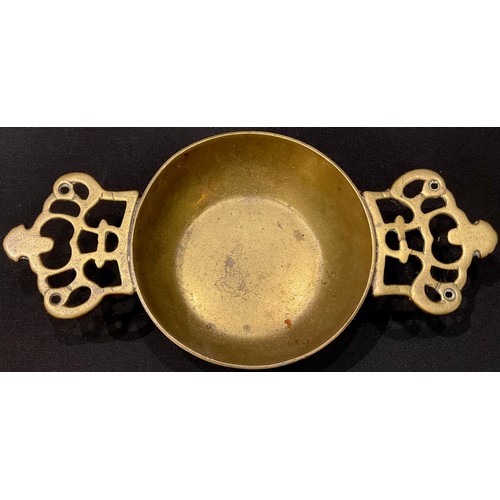 73 - An early 18th century brass porringer, of silver shape, pierced crown lug handles, 21cm wide, c.1730... 