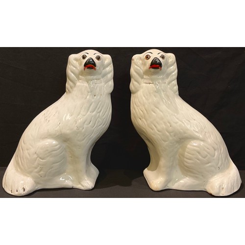 82 - A pair of Victorian Staffordshire Spaniel mantel dogs, glass eyes, 33cm high