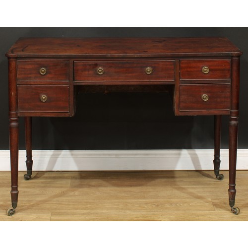 106 - A George III mahogany kneehole writing table, turned legs, brass casters, 78cm high, 108cm wide, 51c... 