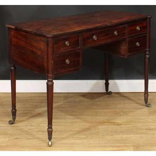 106 - A George III mahogany kneehole writing table, turned legs, brass casters, 78cm high, 108cm wide, 51c... 