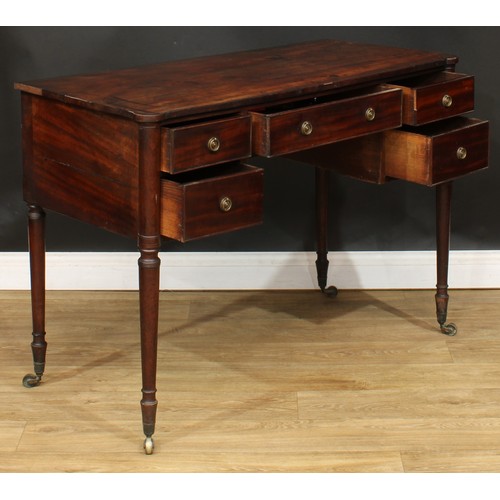 106 - A George III mahogany kneehole writing table, turned legs, brass casters, 78cm high, 108cm wide, 51c... 