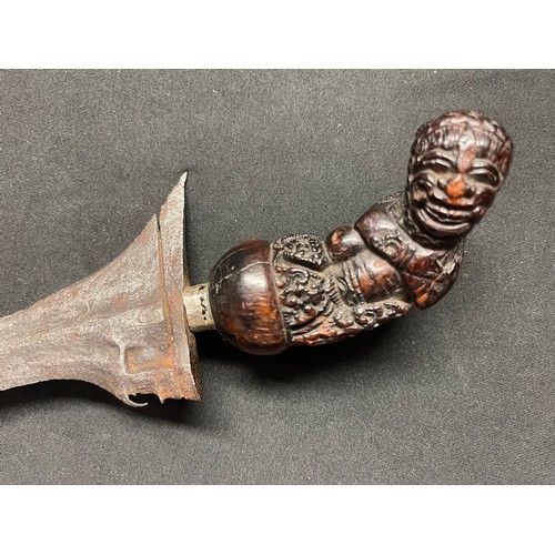 3069 - A Javanese Kris with figural hardwood grip and serpentine blade 315mm in length, overall length 410m... 