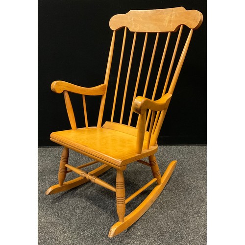 66 - A 20th century beech wood rocking chair.