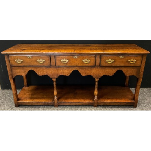 68 - A Titchmarsh and Goodwin 'Yeoman's' oak dresser base - South Wales leg dresser base, having a row of... 