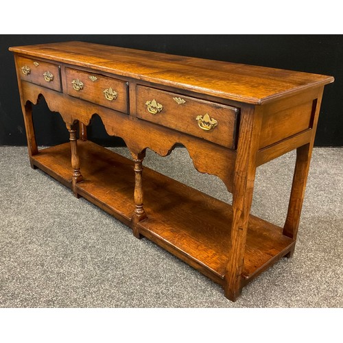 68 - A Titchmarsh and Goodwin 'Yeoman's' oak dresser base - South Wales leg dresser base, having a row of... 