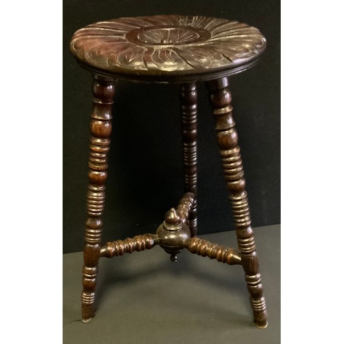 75 - A 19th century carved oak bobbin turned stool, floral shield wheel top, turned legs, conforming stre... 