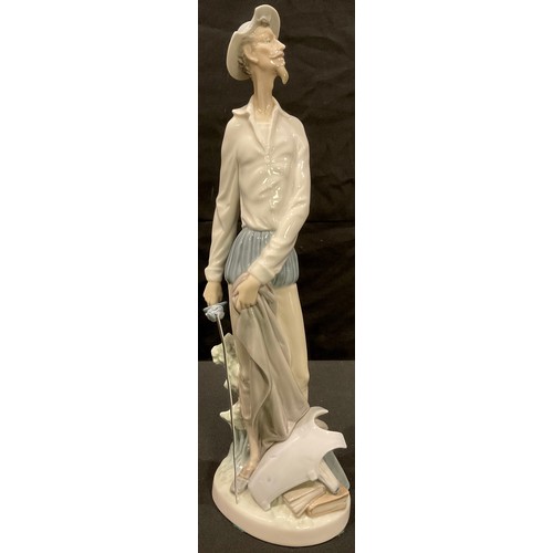 6 - A Lladro figure, The Lamp Lighter, 48cm, printed marks; three others smaller, Don Quixote, Sancho Pa... 