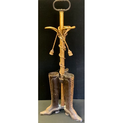 274 - A novelty cast metal umbrella/stick stand as three boots, tassels & staffs, 82cm high