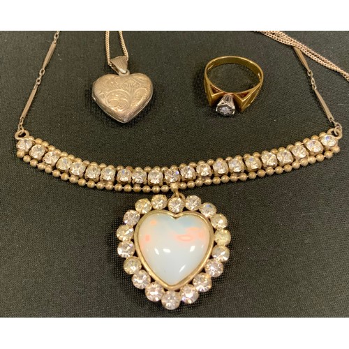 329 - A diamond solitaire ring, illusion set, 18ct gold shank;  a sterling silver heart locket;  etc