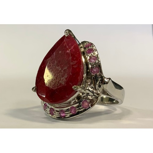 331 - A large ruby cocktail ring, pear cut, 30ct, silver mount