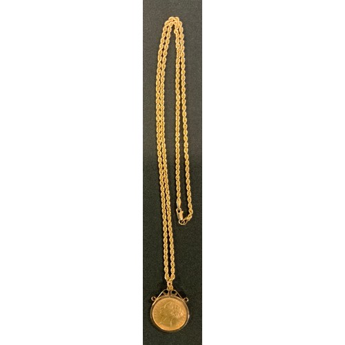 348 - A Victorian shield back half sovereign pendant necklace, 1885, 9ct gold mount, suspended from a 14ct... 