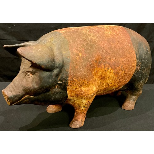 61 - A cast metal painted piggy bank, 46cm wide