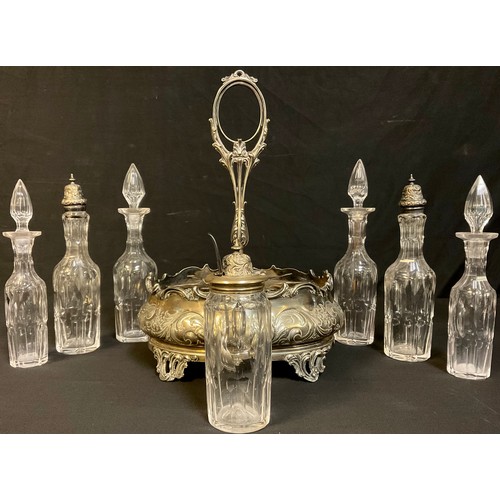 66 - A Victorian silver plated seven bottle cruet stand, embossed with foliate scrolls, original bottles ... 