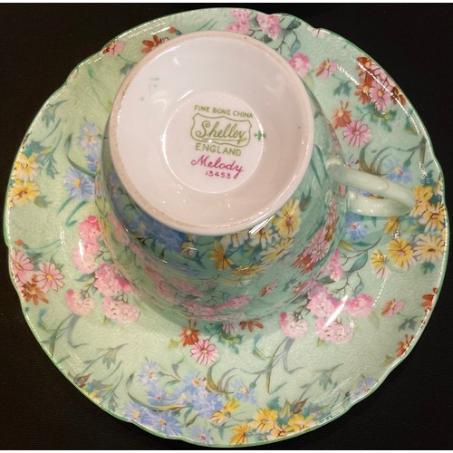 72 - A Shelley Melody pattern chintz tea set, comprising five teacups, saucers and tea plates with gilded... 