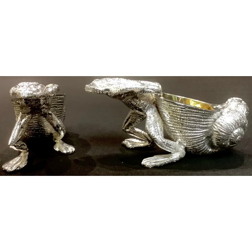 90 - A pair of novelty silver plated table salts modelled as frogs pulling shells, 10cm wide