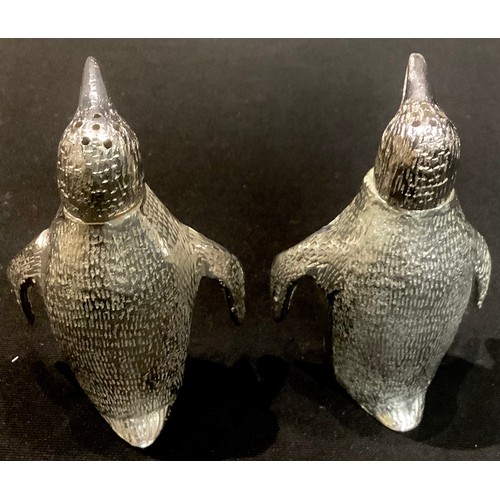 91 - A pair of plated novelty salt and pepper shakers, each modelled as a penguin, 7.5cm high