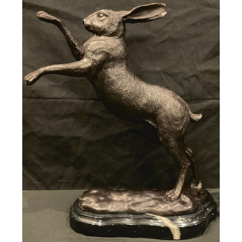 95 - A pair of bronze boxing hares, shaped marble bases, 29cm high, late 20th century