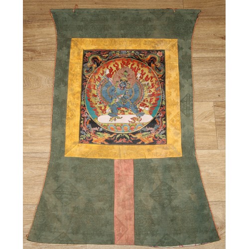 139 - A Tibetan thangka, painted in gouache with Vajrabhairava, laid on a silk scroll, 82cm x 47cm overall