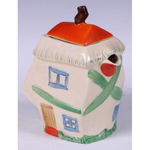 137 - A Staffordshire hot water pot, as a crooked house, decorated in polychrome, angular handle, 19cm hig... 