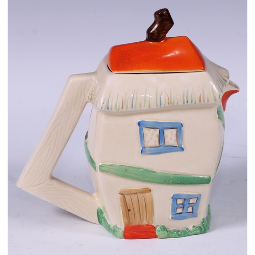 137 - A Staffordshire hot water pot, as a crooked house, decorated in polychrome, angular handle, 19cm hig... 