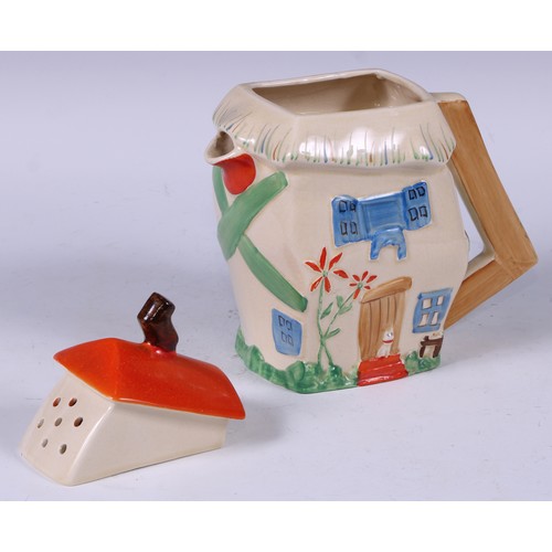 137 - A Staffordshire hot water pot, as a crooked house, decorated in polychrome, angular handle, 19cm hig... 