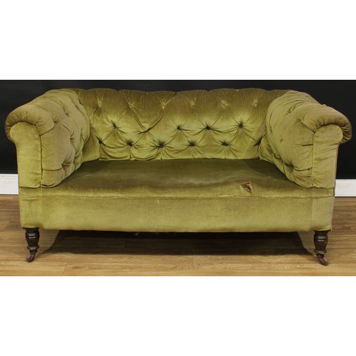 105 - A Victorian Chesterfield sofa, stuffed-over deep button upholstery, turned forelegs, ceramic casters... 