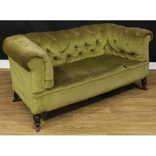 105 - A Victorian Chesterfield sofa, stuffed-over deep button upholstery, turned forelegs, ceramic casters... 