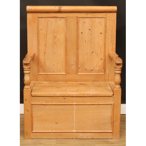 110 - A pine box settle or bench, two panel back, hinged seat, 124.5cm high, 91cm wide, the seat 76cm wide... 