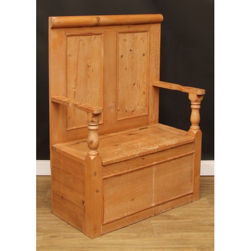 110 - A pine box settle or bench, two panel back, hinged seat, 124.5cm high, 91cm wide, the seat 76cm wide... 