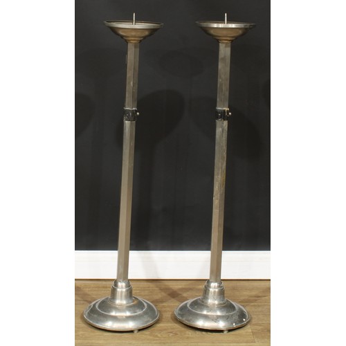 205 - A pair of Arts & Crafts design floor-standing pricket candlesticks, 112cm high, the drip tray 21cm d... 