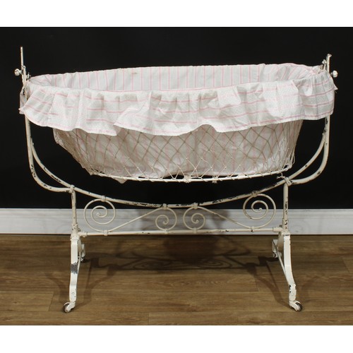 210 - An early to mid-20th century French rocking cradle or crib, 95.5cm high, 115cm wide, 53.5cm deep