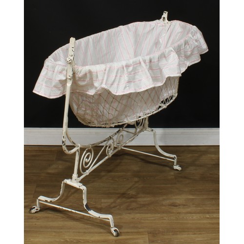 210 - An early to mid-20th century French rocking cradle or crib, 95.5cm high, 115cm wide, 53.5cm deep