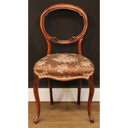 217 - A set of four Victorian walnut balloon back dining chairs, cabriole legs, 84cm high, 45cm wide, the ... 