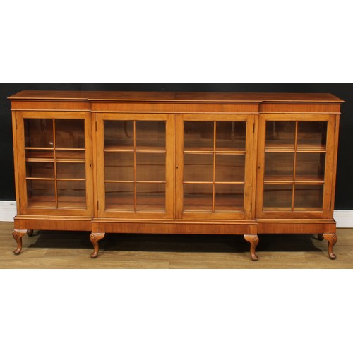 220 - A George II inspired walnut break-centre low library bookcase, 90.5cm high, 185cm wide, 36cm deep; a... 