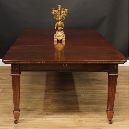 594 - A late Victorian mahogany extending dining table, rounded rectangular top with two additional leaves... 