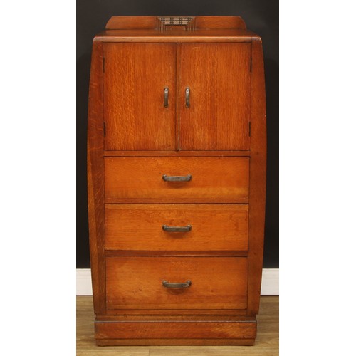 603 - An Art Deco oak and veneer press cupboard, of small proportions, half-gallery above a pair of doors ... 