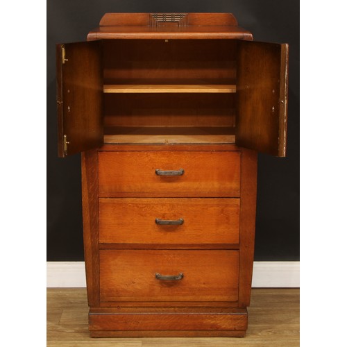 603 - An Art Deco oak and veneer press cupboard, of small proportions, half-gallery above a pair of doors ... 