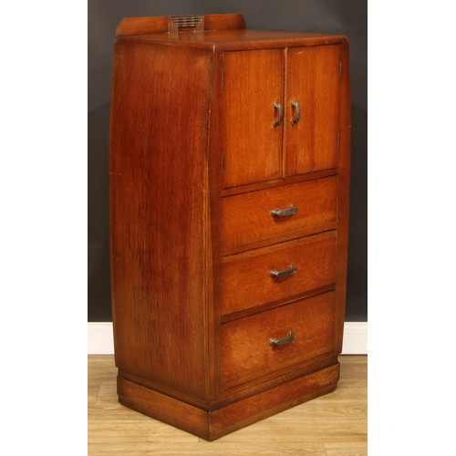 603 - An Art Deco oak and veneer press cupboard, of small proportions, half-gallery above a pair of doors ... 